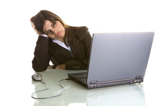 businesswoman with tired expression working with laptop computer isolated on white background