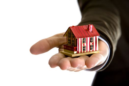 woman hand holding small house - real state concept