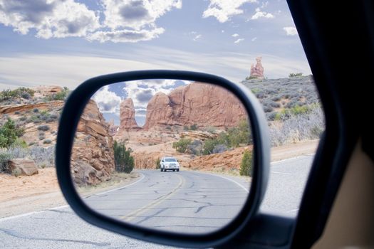 rear view mirror view of Arches area mountains and spires in Utah USA