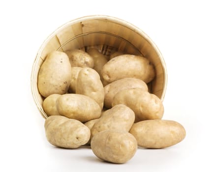 Potatoes in a woven basket on a white background