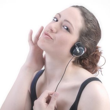 Portrait of a woman with long curly hair listening to music