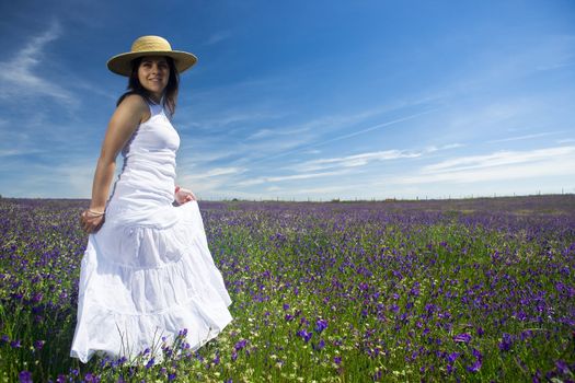 beautiful young woman with white dress in colorful landscape