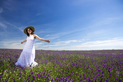 beautiful young woman in white dress enjoying nature