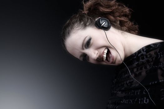 Portrait of a woman with long curly hair and headphones