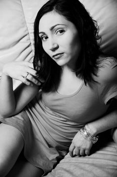 Beautiful young  woman relaxing on a white sofa 