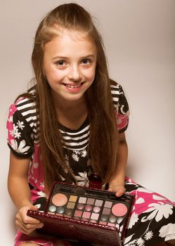 little girl with cosmetics