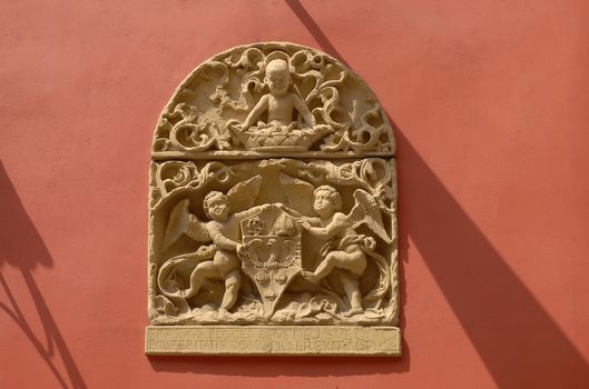 Stone emblem relief from ancient house facade. Old town Krakow in Poland.