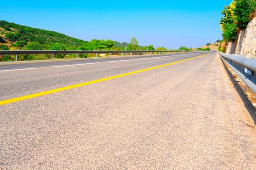 Empty Highway In North Galilee, Israel, Against Blue Sky.
