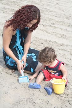 Young happy family together on the beach