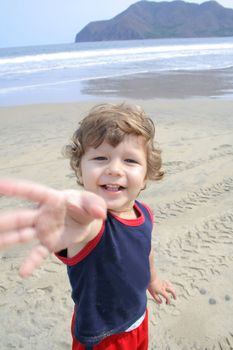 Young child playing in the sand on the beach