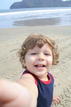 Young child playing in the sand on the beach