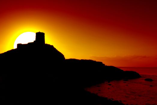 Romantic castle on the cliff silhouette and beautiful sunset