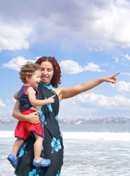 Young happy family together on the beach