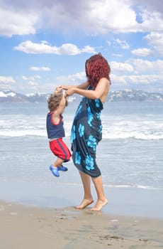 Young happy family together on the beach