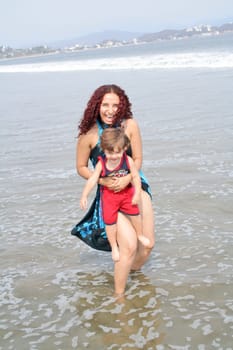 Young happy family together on the beach