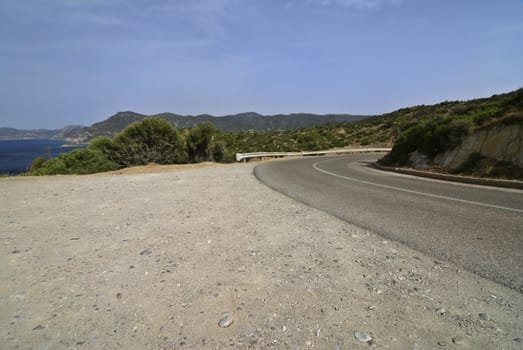 Road near the sea in the mountains of Sardinia. Italy.