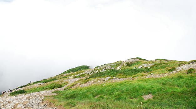 Touristic mountain track in the fog.