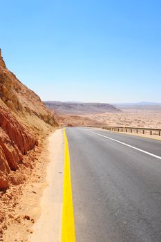 Empty Highway In Desert Negev, Israel, Against Blue Sky.
