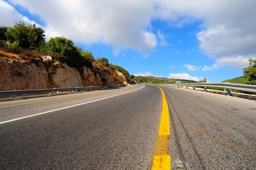 Empty Highway In North Galilee, Israel, Against Blue Sky.