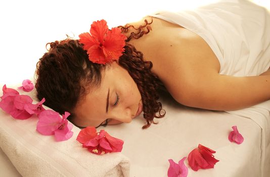 Young woman on a white massage table in a spa treatment