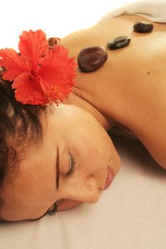 Young woman on a white massage table in a spa treatment