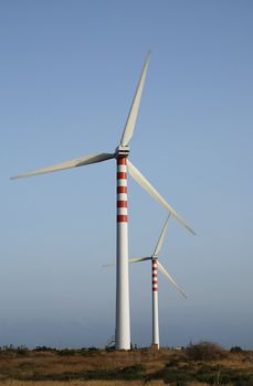 Two wind turbines generating energy - with slight motion blur