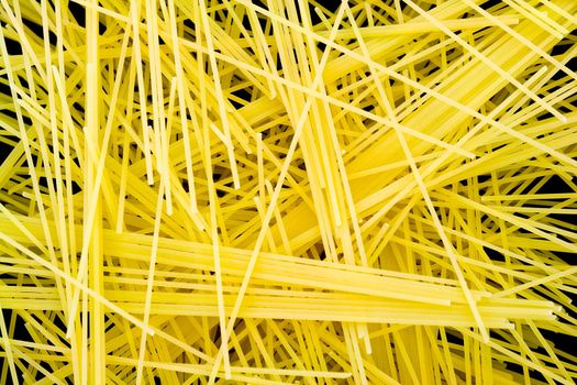 Macaroni background. yellow spaghetti close up.