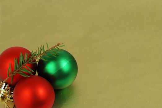 Detail of three christmas balls and chain on a golden background frame
