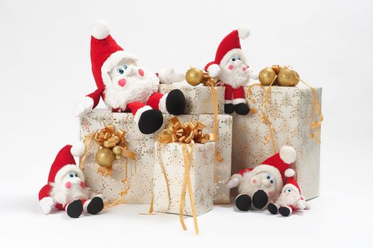 Christmas gifts and five gnomes isolated on white background