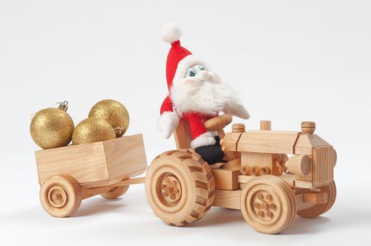 Gnome driving tractor with christmas toys in trailer