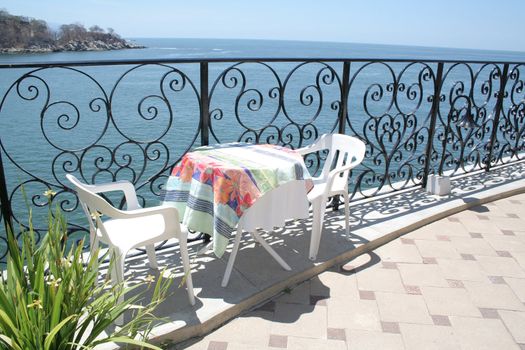 Restaurant table under umbrella overlooking beautiful ocean