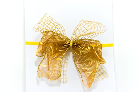 White gift box with yellow ribbon and bow on white