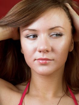 Portrait of a beautiful, sexy girl on red background 