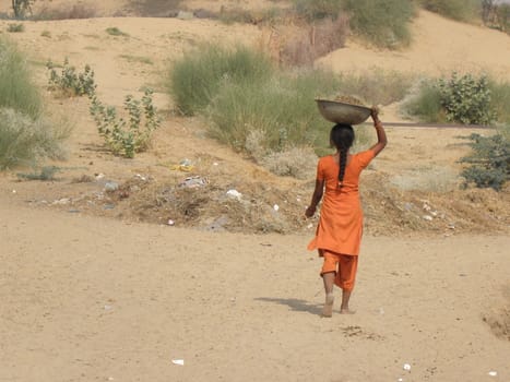 Girl walking around her house in Rajasthan