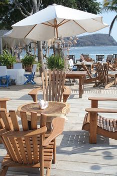 Restaurant table under umbrella overlooking beautiful ocean