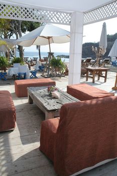 Restaurant table under pergola overlooking beautiful ocean