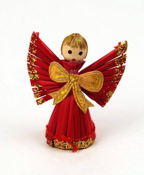 Isolated Christmas Cherub made from straw with ribbon