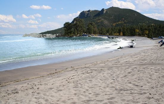 beautiful beach with mountain and pine trees