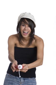 Teenage girl wearing a black tube top, knitted hat and jeans with holes squeezing a ketchup bottle
