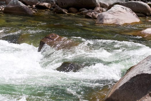 green water and stones in the stream 
