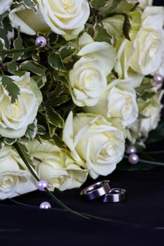 wedding rings and white roses