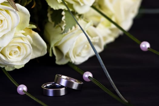 wedding rings and white roses