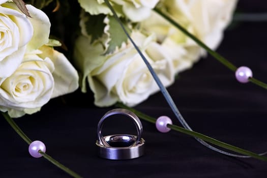 wedding rings and white roses