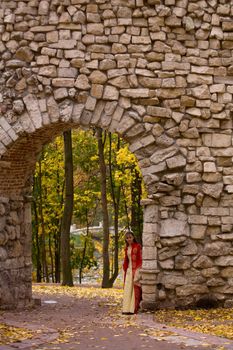 lady in medieval red dress standing in doorway
