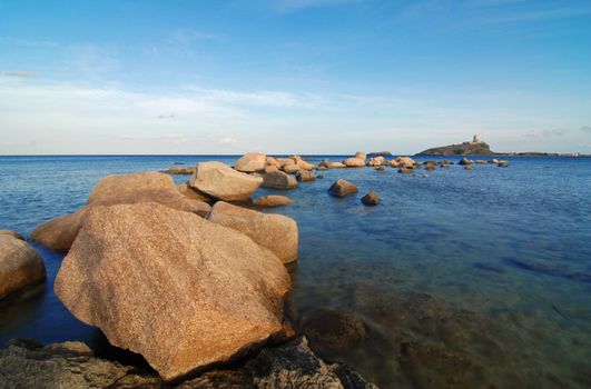 Sardinia sea with lighthouse and stone pier