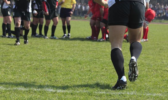 Abstract image of a team game (rugby) moment- substitution.