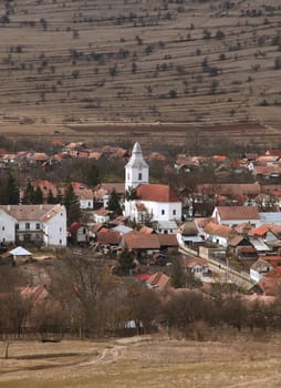 Romanian village in a mountainous region during very early spring season. Location: Rametea, Transylvania.