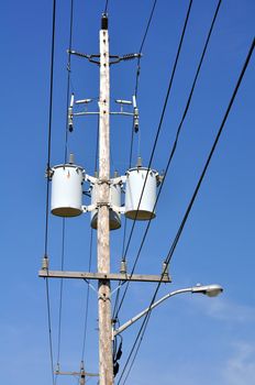 Electrical power pole with associated distribution lines and components.