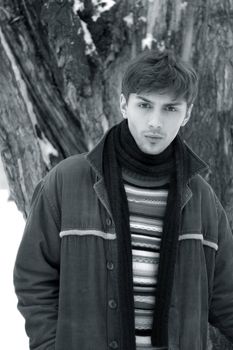 Portrait of the young man in the winter. b/w+blue tone