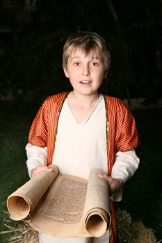 Boy reading from a gevil parchment scroll.  This one is written on goat skin.